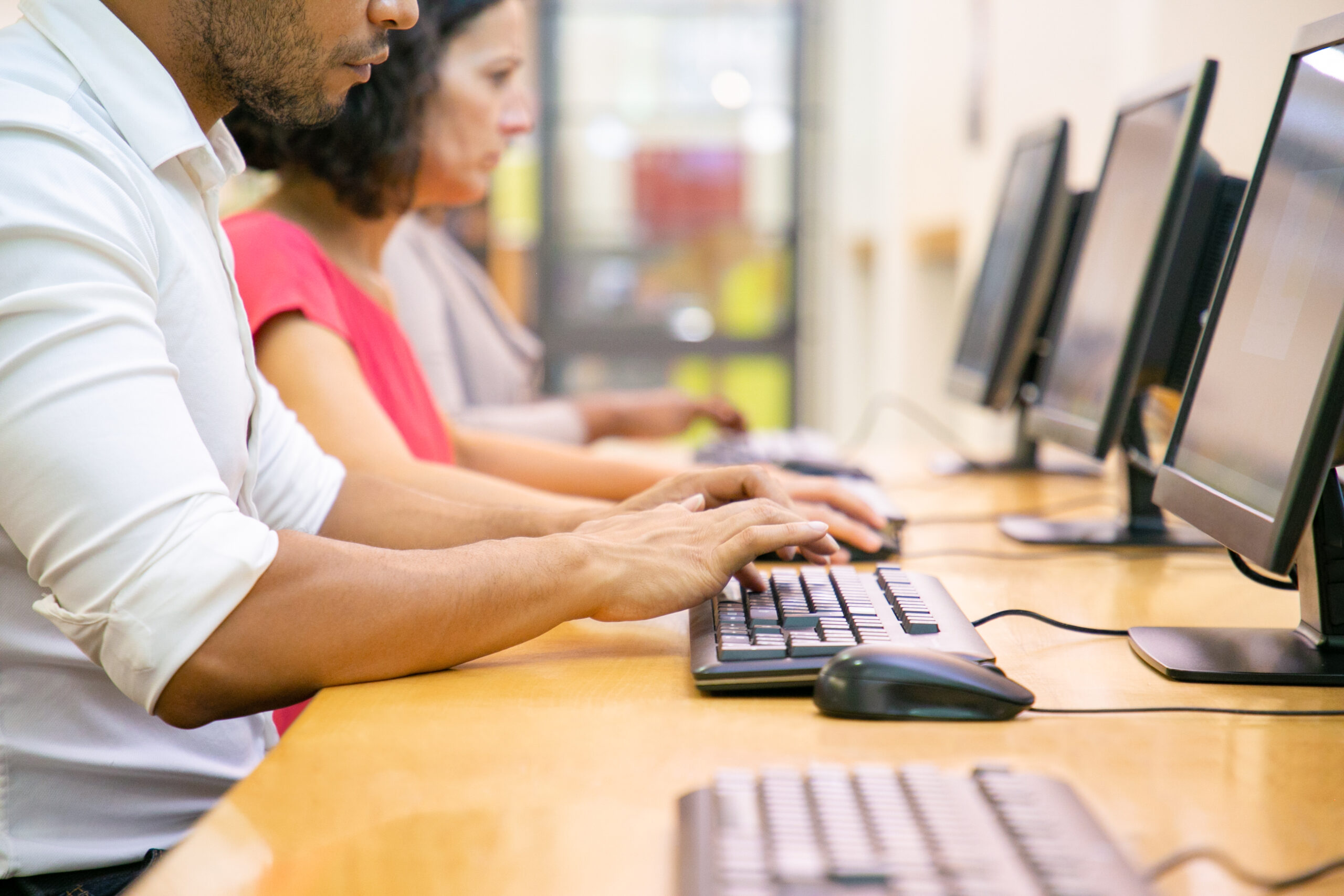 Multiethnic group of students working in computer class