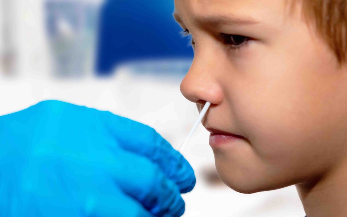 Doctor,Tacking,A,Coronavirus,(covid-19),Test,To,A,Boy’s,Nose